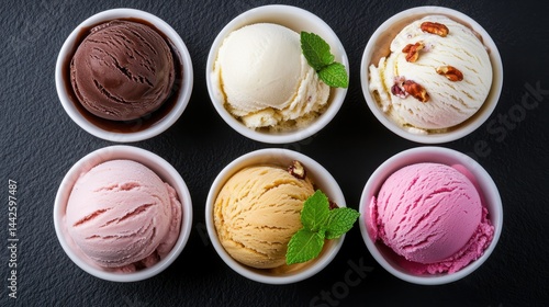 A row of six bowls of ice cream, each with a different flavor. The bowls are arranged in a row on a counter