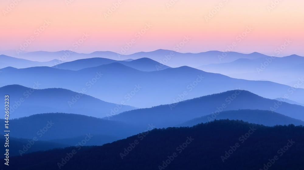 Fototapeta premium Serene layers of blue and violet mountains at sunset