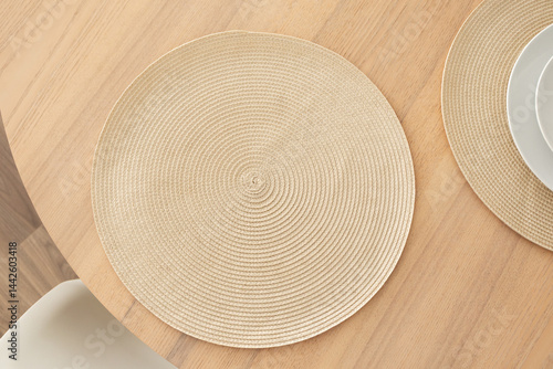 Minimalist aesthetic woven placemat on wooden table