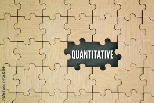 Photography wooden puzzle with the word quantitative