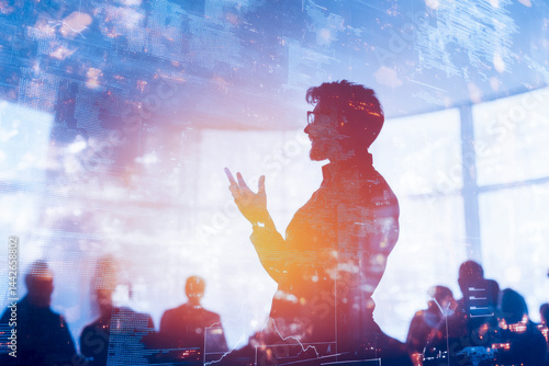 Silhouetted businessman giving a presentation in a digital environment, overlaid with futuristic data and technology interface graphics