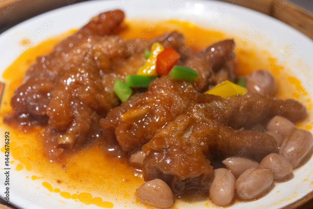 Braised chicken feet dim sum served on a bamboo steamer