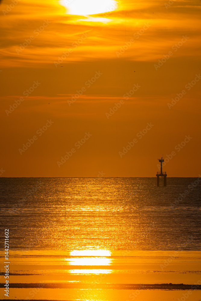 A breathtaking view of the sun setting over the ocean, casting a golden glow across the sky and reflecting on the water. A lighthouse stands in the distance, adding depth to the serene coastal scene A breathtaking view of the sun setting over the ocean, casting a golden glow across the sky and reflecting on the water. A lighthouse stands in the distance, adding depth to the serene coastal scene