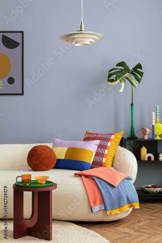 Interior desgin of modern living room interior with mock up poster frame, colorful decorations and accessories, plants, sofa, coffee table. Blue wall. Home decor. Template.
