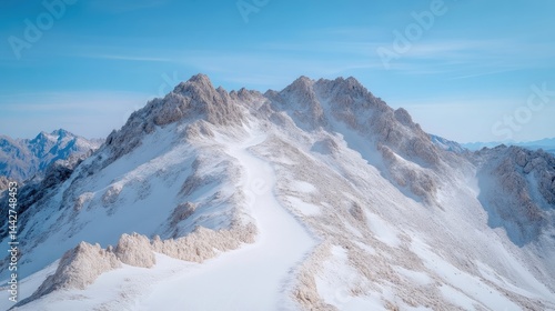 Wallpaper Mural Snowy mountain peaks under a clear blue sky.  A high-angle view of a snow-covered mountain range with a ridgeline path.  Sunlight illuminates the pristine white snow Torontodigital.ca