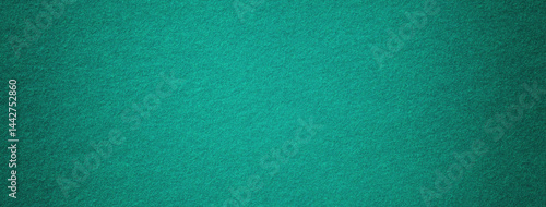 Texture dark green background from felt textile material with vignette, macro. Structure vintage olive fabric cloth
