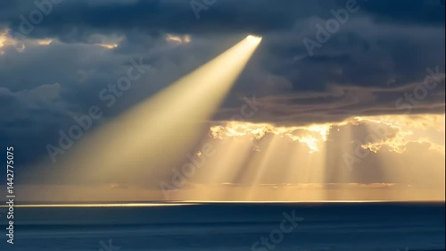 Golden Rays Pierce Dark Clouds Over Calm Ocean