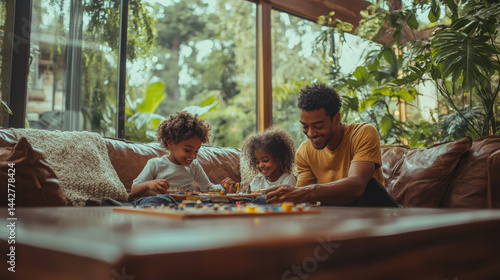 Happy Black Father Playing with Two Children on a Brown Sofa Near Large Window