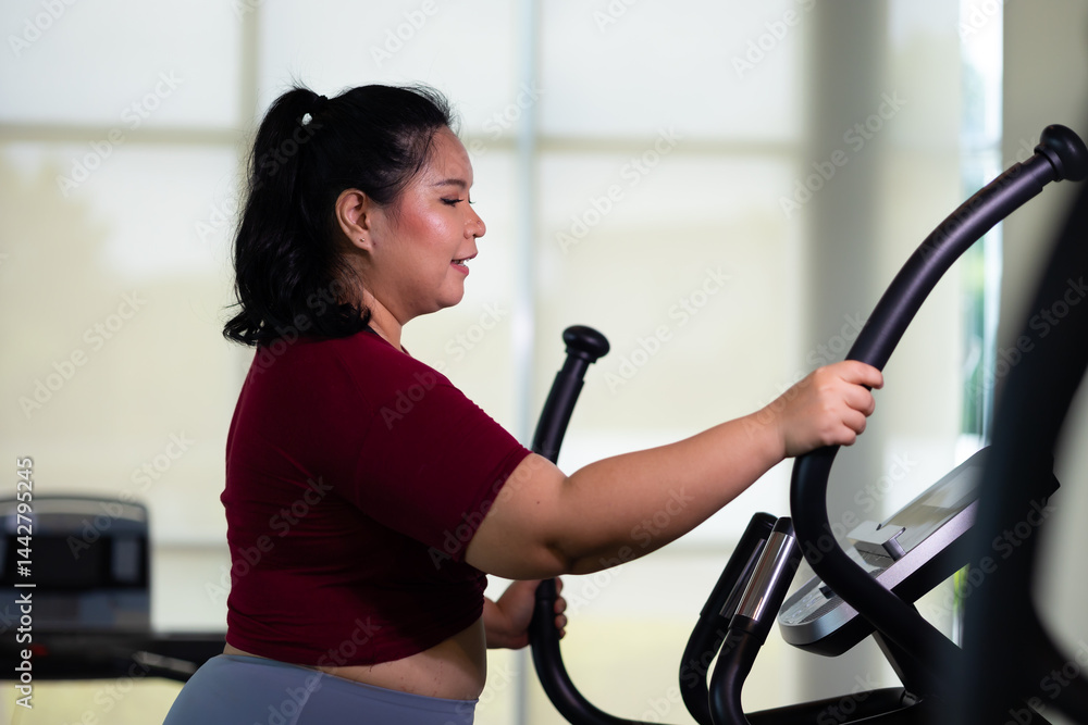 Exercise. beautiful young chubby overweight woman wearing sporty fitness clothes doing exercise indoors at gym fitness sport club, body and health care