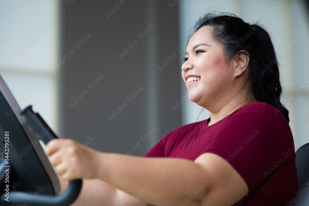 Exercise. beautiful young chubby overweight woman wearing sporty fitness clothes doing exercise indoors at gym fitness sport club, body and health care