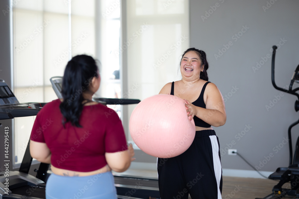 gymnastic ball. beautiful young chubby overweight woman in sportswear doing exercise indoors at gym fitness sport club, body and health care