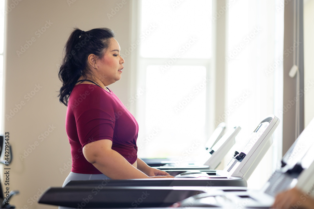 jogging on treadmill. beautiful young chubby overweight woman in sportswear doing exercise indoors at gym fitness sport club, body and health care
