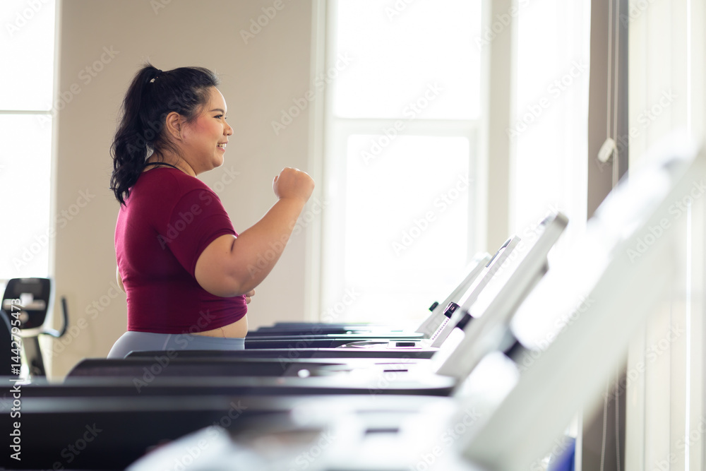 jogging on treadmill. beautiful young chubby overweight woman in sportswear doing exercise indoors at gym fitness sport club, body and health care