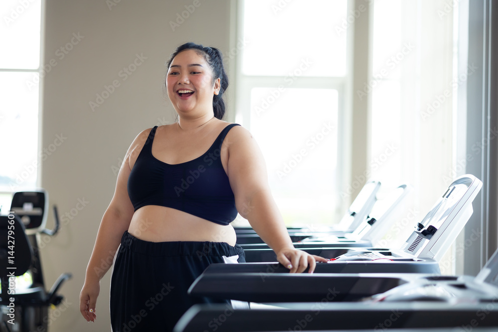 Portrait woman Exercise. beautiful young chubby overweight woman wearing sporty fitness clothes doing exercise indoors at gym fitness sport club, body and health care