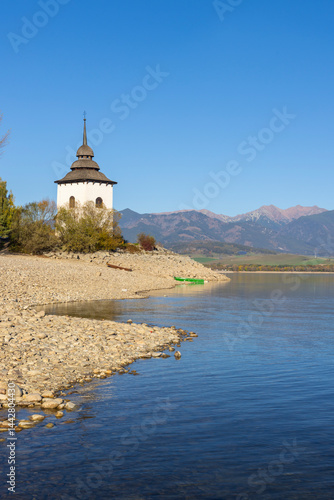 Obraz na płótnie Liptovska Mara reservoir with the church tower of the flooded village and the Western Tatras in background w salonie