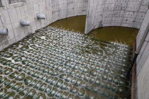 Biological treatment process in aeration basin closeup. Specialized equipment serves for breakdown of organic pollutants by infusion of oxygen