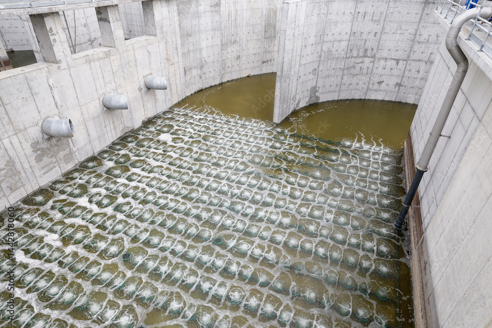 Biological treatment process in aeration basin closeup. Specialized equipment serves for breakdown of organic pollutants by infusion of oxygen