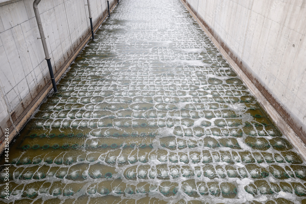Biological treatment process in aeration basin closeup. Specialized equipment serves for breakdown of organic pollutants by infusion of oxygen