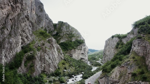 Tableau sur toile View of a mountain valley with rocks overgrown with green vegetation