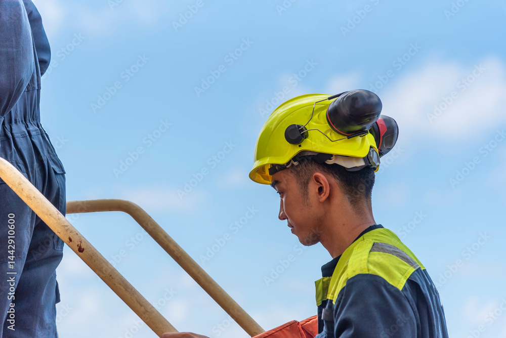 A sailor entering the lifeboat during an abandon ship drill, a crucial training exercise to ensure crew safety and preparedness in case of emergency. A sailor entering the lifeboat during an abandon ship drill, a crucial training exercise to ensure crew safety and preparedness in case of emergency.
