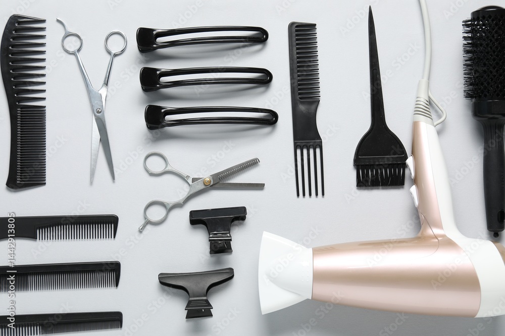 Fototapeta premium Different hairstyling tools on white background, flat lay