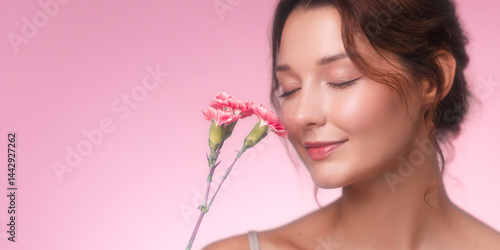 Studio banner featuring a graceful young woman with closed eyes and a soft smile, gently enjoying the scent of pink carnations. Her glowing skin and the pastel pink backdrop create a peaceful