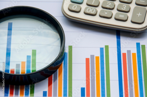Graph analysis with calculator and magnifying glass. Financial analysis concept
