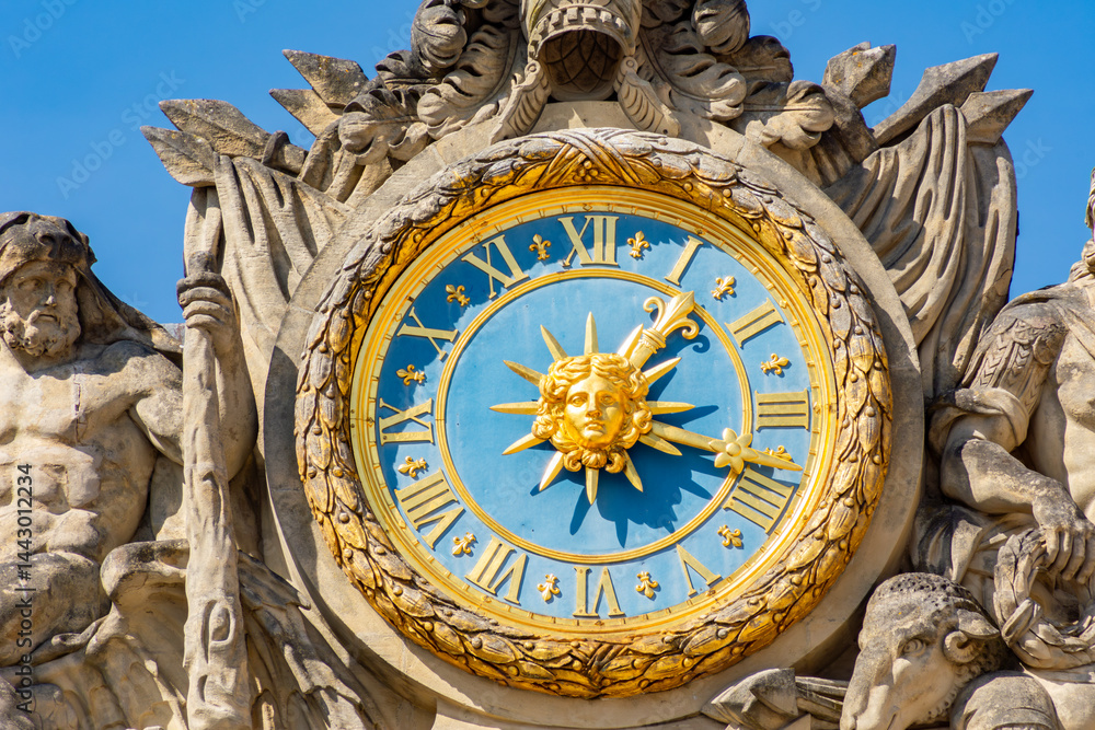 Clock on facade of Versailles palace, Paris suburbs, France