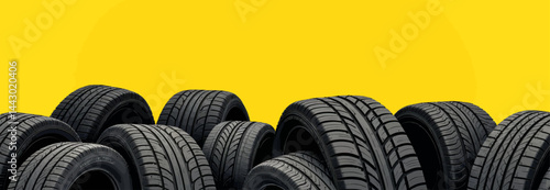 Obraz na płótnie Pile of New Black Car Tires on Yellow w salonie