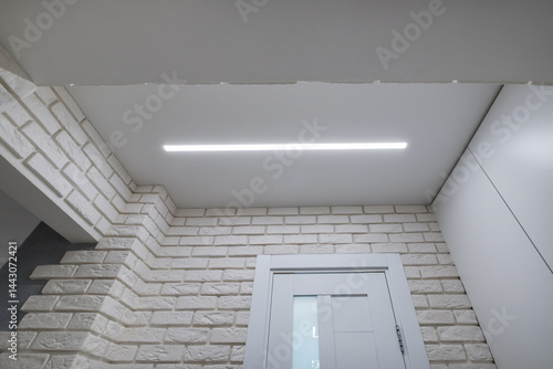 Obraz na płótnie suspended ceiling with halogen spots lamps in form of squares and rectangles and drywall construction in empty room in apartment or house. Stretch ceiling white and complex shape. w salonie