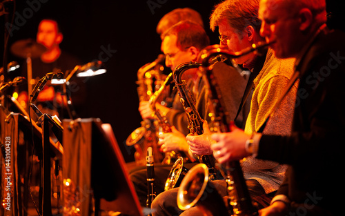 Big Band Saxophones. A view across the sax section in a big band performing together live on stage.