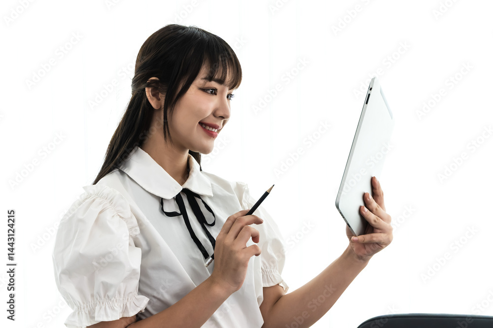 Female Asian office worker working on digital tablet in office Female Asian office worker working on digital tablet in office