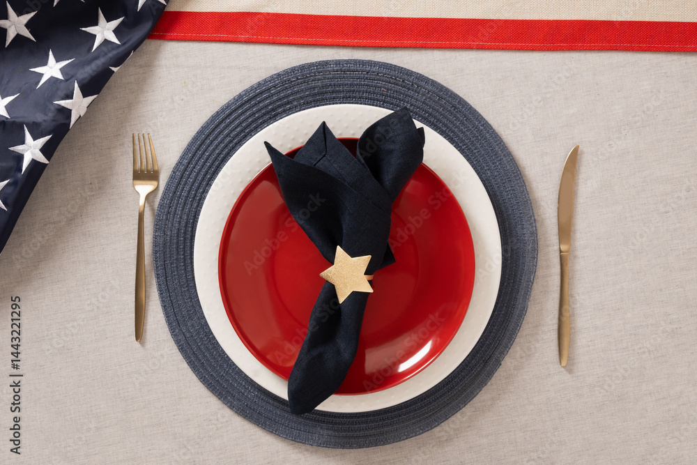 Table setting for USA Independence Day. Festive dinner with red plate and decoration in USA national flag colors white, red and blue. View from above. Copy space. Close up.