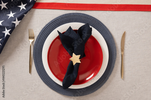 Obraz na płótnie Table setting for USA Independence Day. Festive dinner with red plate and decoration in USA national flag colors white, red and blue. View from above. Copy space. Close up. w salonie