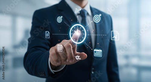 Wallpaper Mural Man in Blue Suit Touching Digital Interface with Floating Business Icons Against Blurred Background Torontodigital.ca