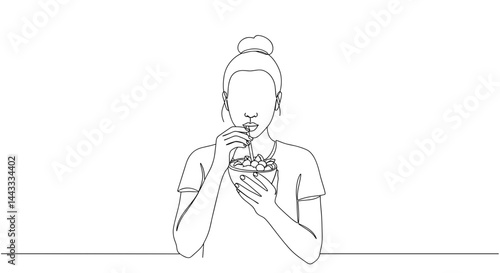Woman enjoying a snack while sitting against a minimal background  