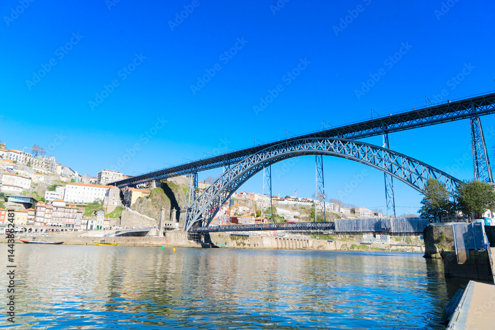 Naklejka premium Picturesque, colorful view at old town Porto with famous bridge, Portugal with bridge Ponte Dom Luis over Douro river. Oporto, touristic mediterranean city