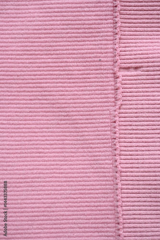 Fototapeta premium pink texture of knitted synthetic fabric as a background, pink smooth symmetrical lines of synthetic fabric 