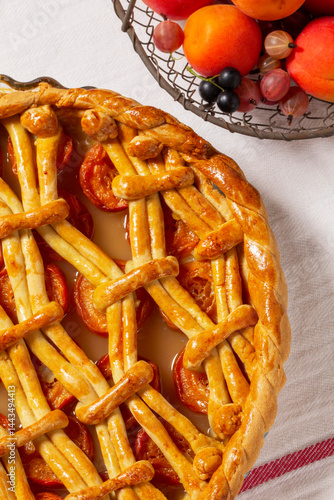 Obraz na płótnie Apricot pie decorated with dough ornament and a metal basket with fruits and berries. w salonie