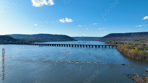 Shocks Mills Bridge on the Susquehanna River in Harrisburg Pennsylvania. Beautiful drone photograph of open Pennsylvania landscape.  Open skies and clear views of sounding mountains and flowing river.