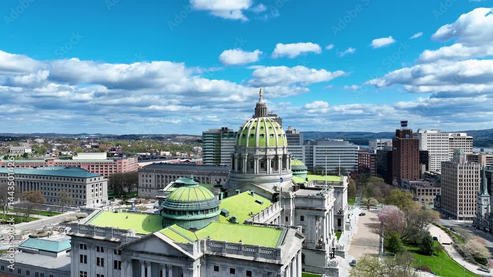 Stunning drone video capturing the Pennsylvania State Capitol building in Harrisburg from above. The image focuses on the building’s iconic dome, adorned in green and gold, standing majestically again