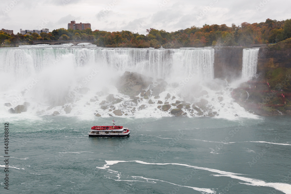 Fototapeta premium Niagara Falls and a tour boat with people in Canada, American Falls