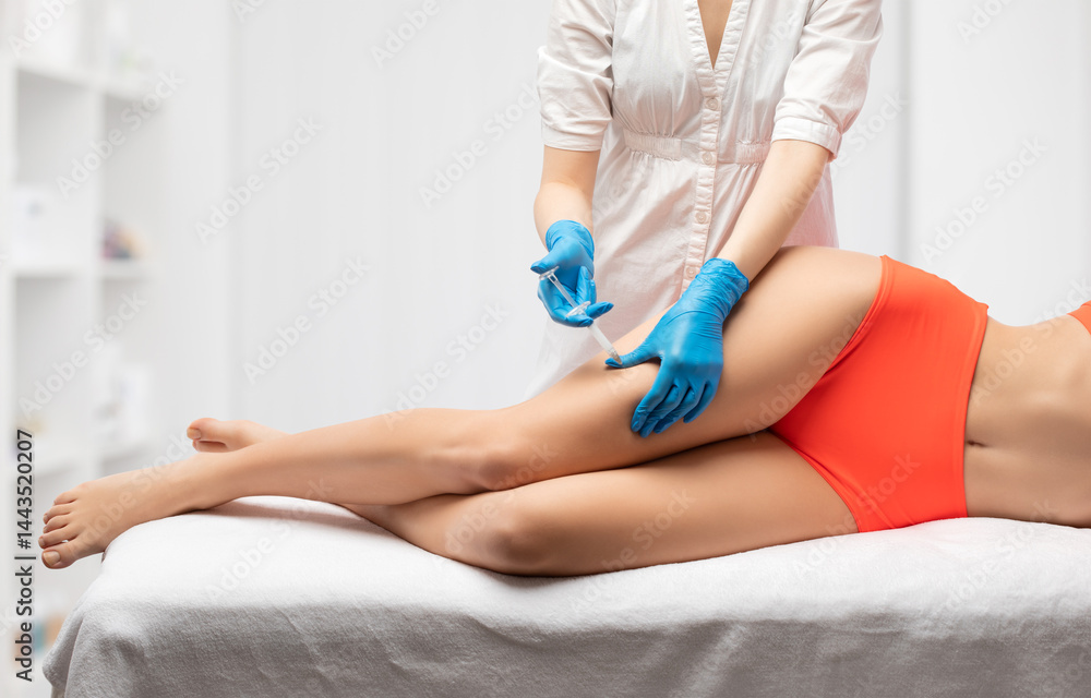 Fototapeta premium Lipolytic injections to burn fat on the body of a woman. Female aesthetic cosmetology in a beauty salon.Cosmetology concept.
