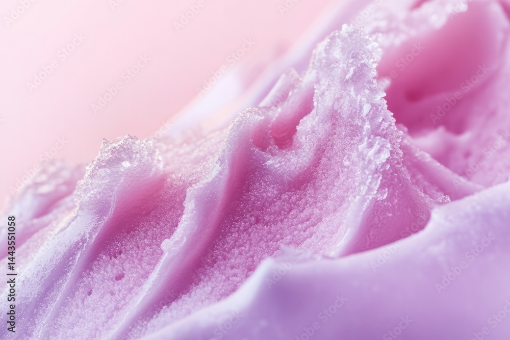 Close-up view of soft pink whipped cream with delicate textures on a pastel background