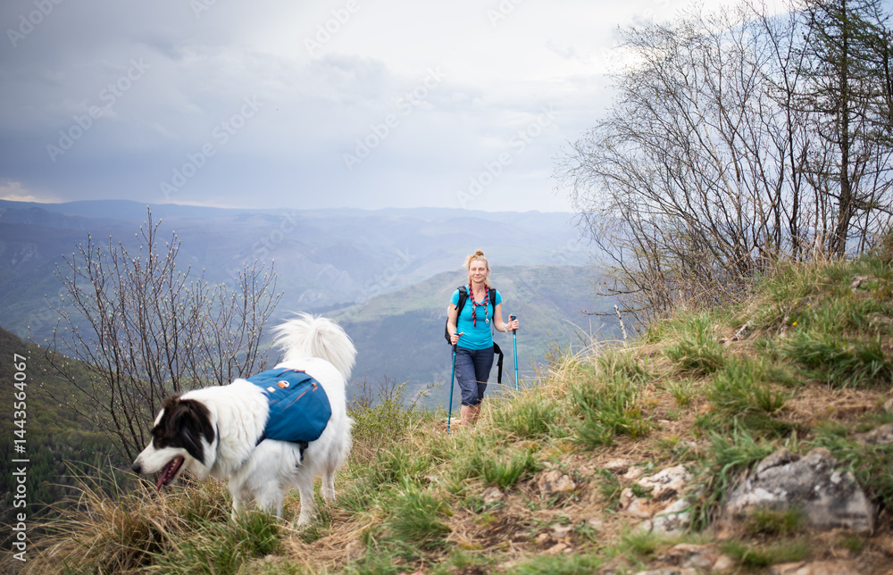 fit woman hiking with her dog