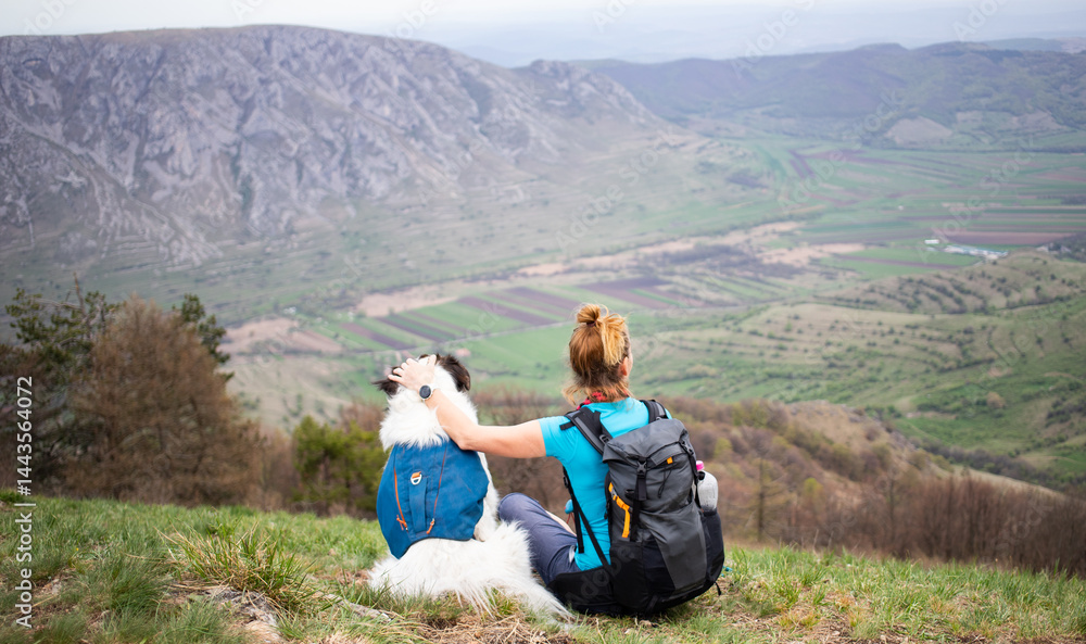 fit woman hiking with her dog