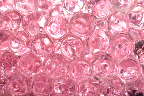 Obraz na płótnie A macro close-up reveals a dense cluster of translucent pink gel beads, showing their round shapes and internal reflections w salonie
