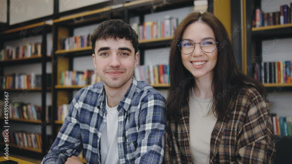 Young adults enjoy their time reading in a cozy bookstore with shelves filled with colorful books during the afternoon Young adults enjoy their time reading in a cozy bookstore with shelves filled with colorful books during the afternoon