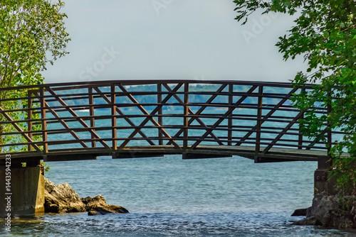 Wooden pedestrian bridge on lake Simcoe at Innisfil beach park, Ontario, Canada