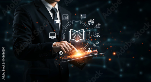 A man in a suit using a tablet with educational icons surrounding an open book in a digital display